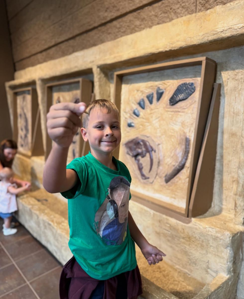 Camper holding up a fossil he found