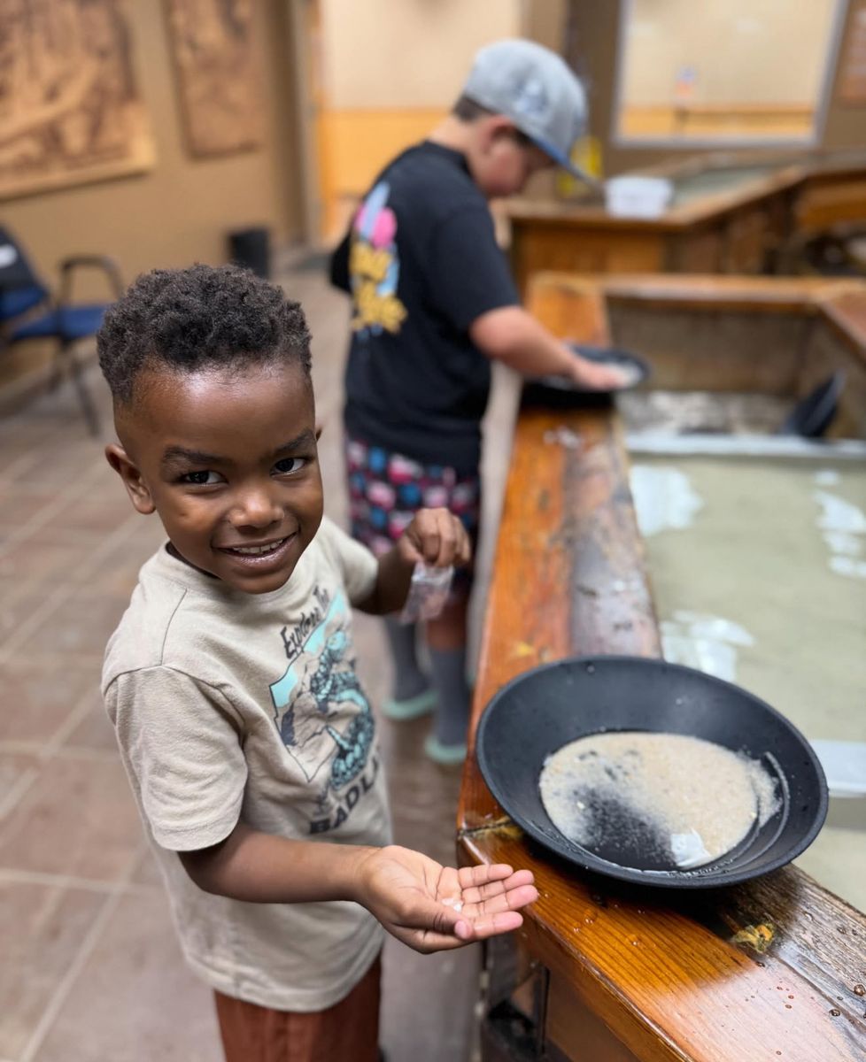 Camper showing the gems he found while panning