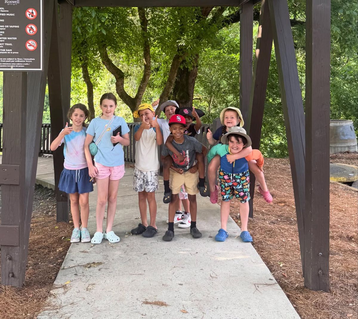 Group of campers giving thumbs up at a Roswell park