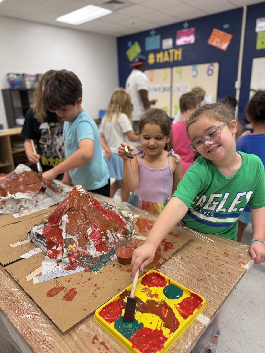 Students painting papier-mâché volcanoes