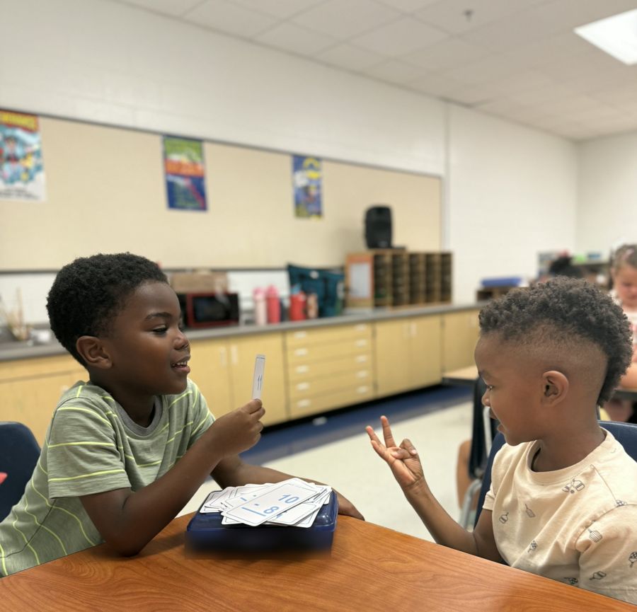 Two students practicing math facts with flash cards