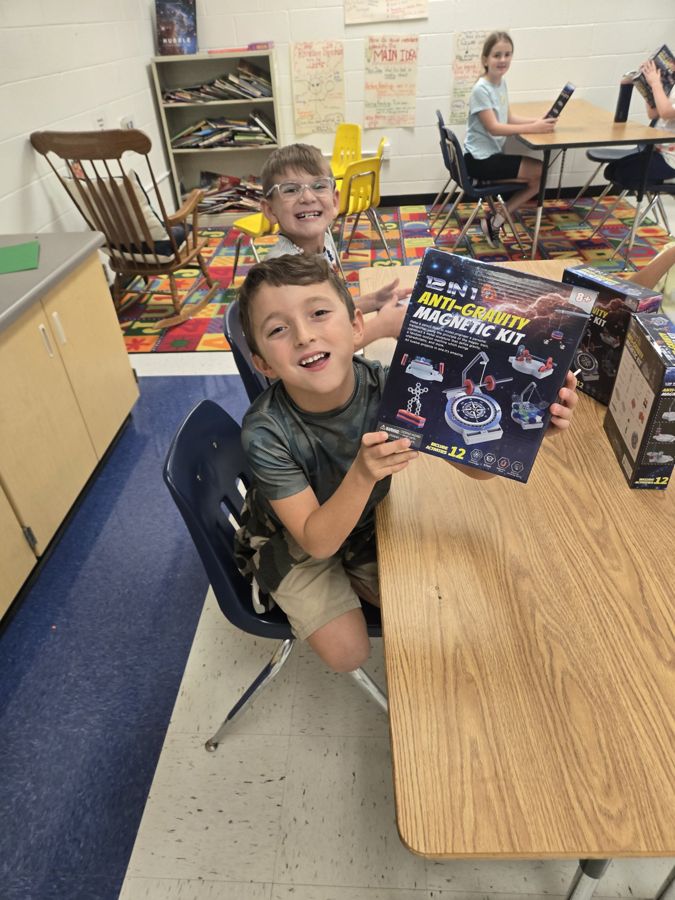 Student holding a STEM magnet kit