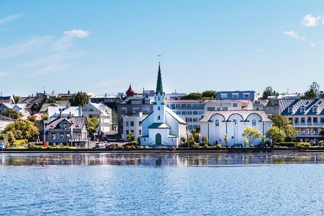 Colorful houses and church along Reykjavík's city pond